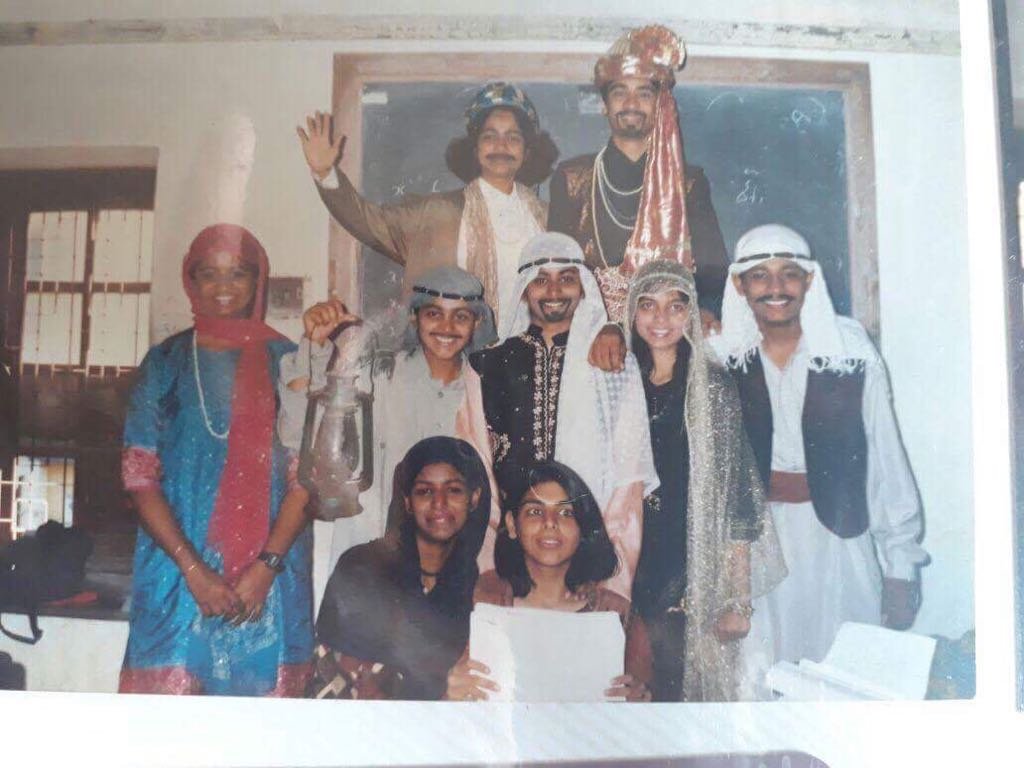 Cast of an early theater production in India, in period costume